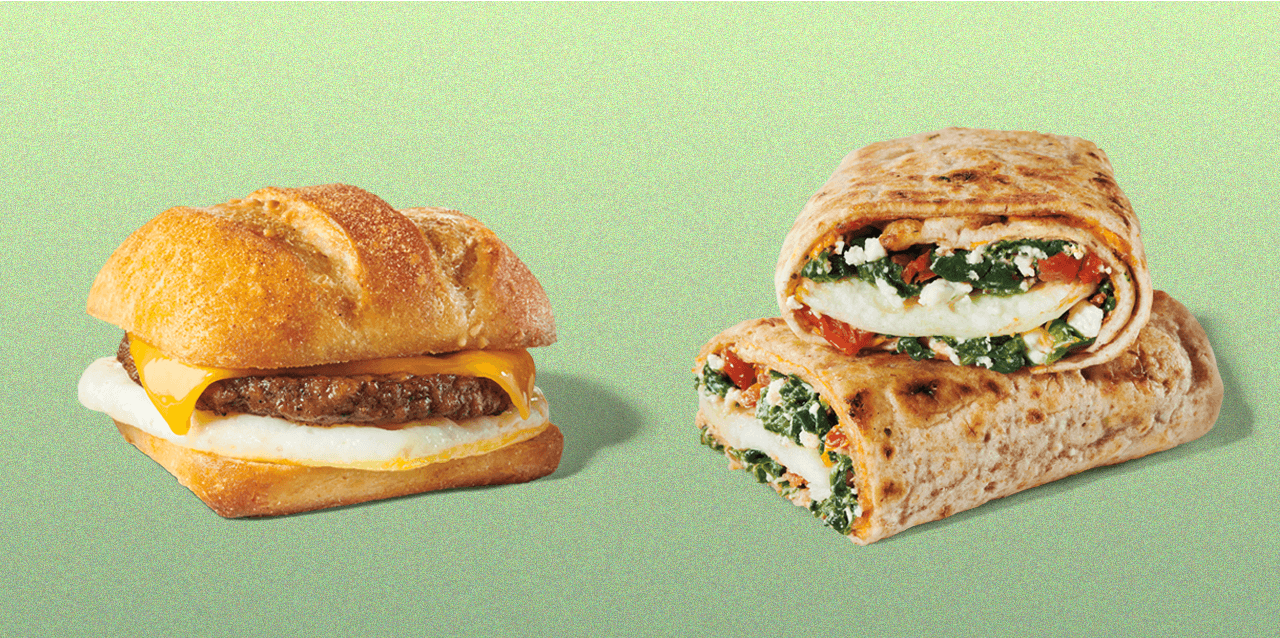 Layered sandwich next to a whole-wheat wrap cut in half.