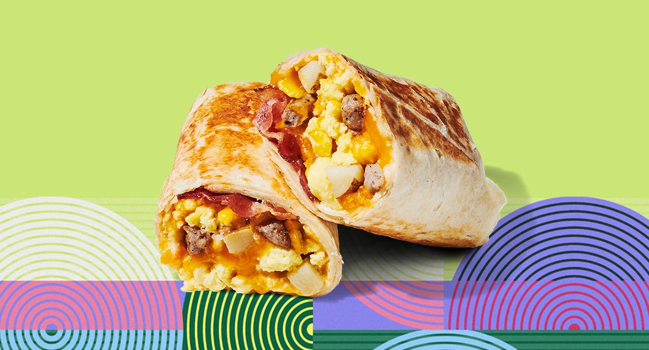 A breakfast wrap sliced in half and stacked on itself, revealing the ingredients inside.