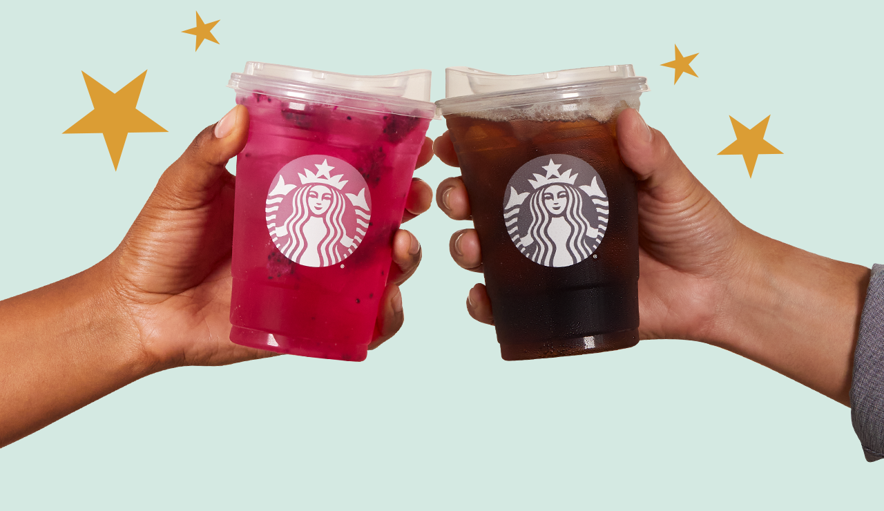 Two hands cheers-ing together, one with a Starbucks Mango Dragonfruit Starbucks Refreshers&reg; Beverage and other with Starbucks Iced Coffee on light green background with Stars.