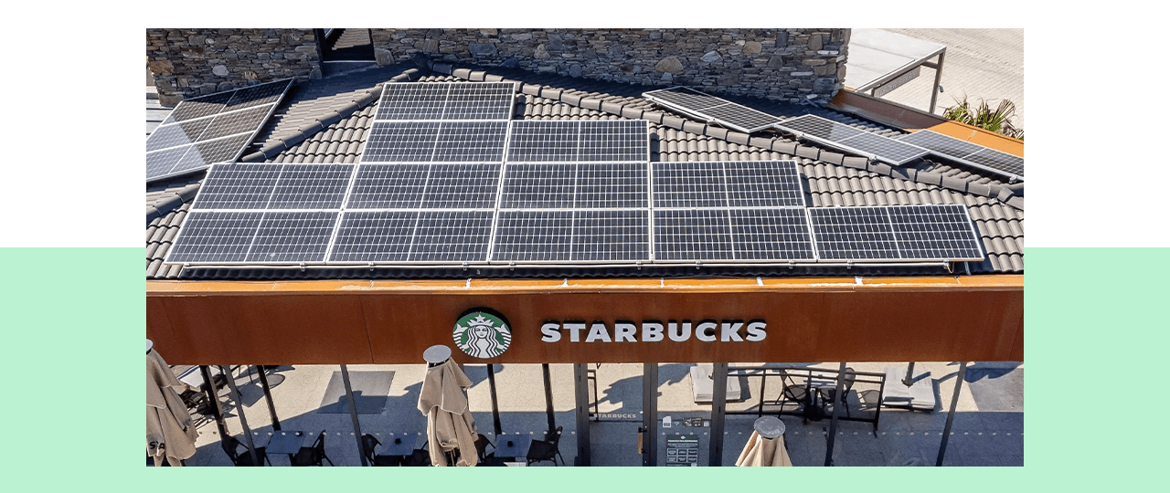 An image of solar panels on top of a Starbucks store.
