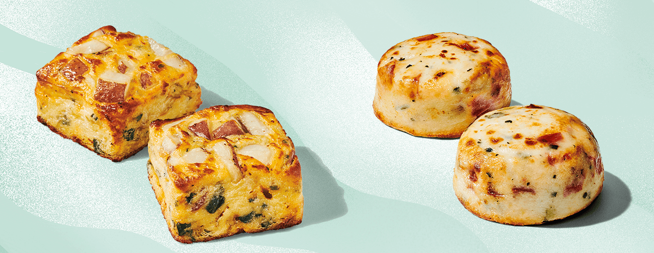 Two square potato bakes and two egg bites on a light blue background.                                            