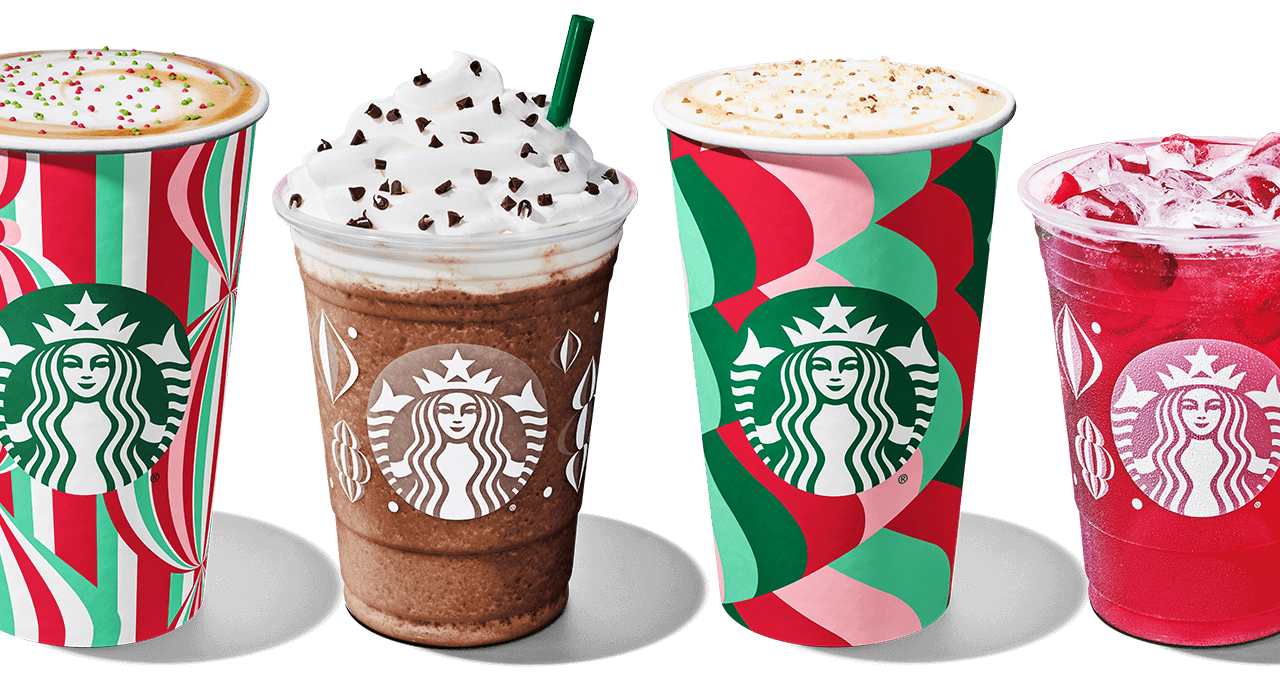 A line up of four different Starbucks holiday to go drinks.