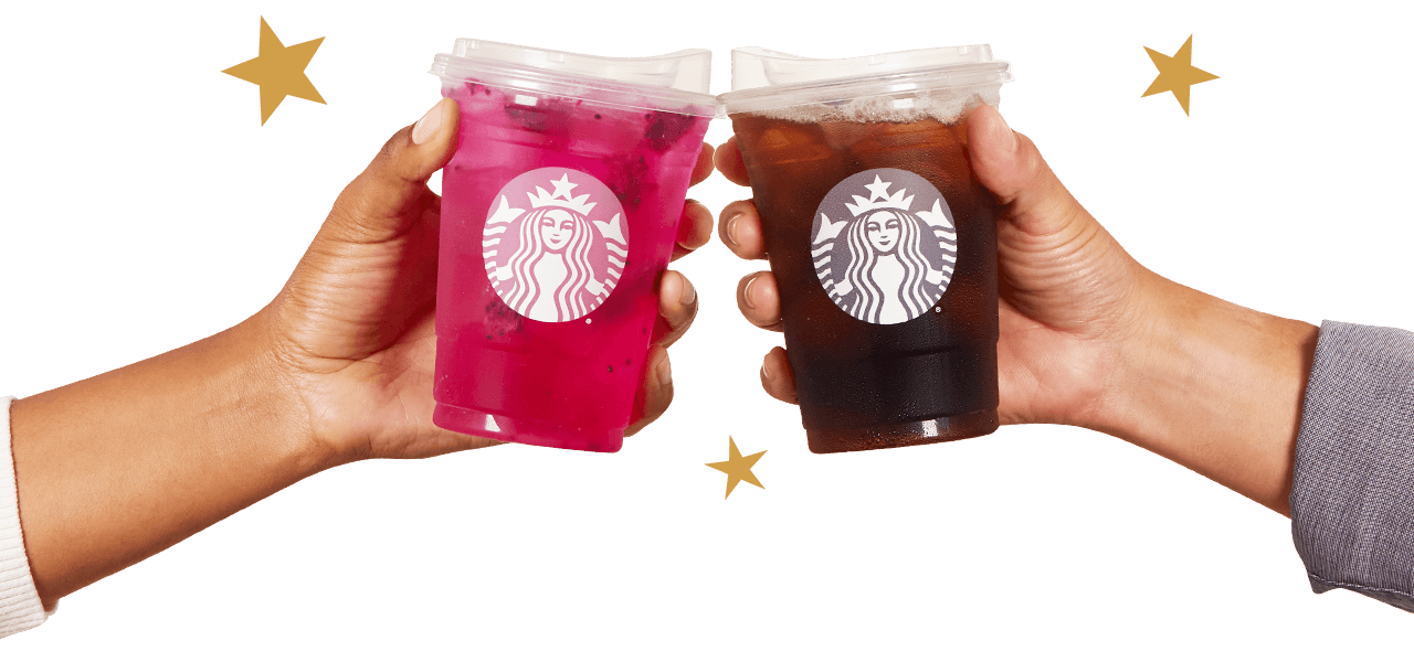 A photograph of two hands each holding a Starbucks to-go cup with gold Stars surrounding the cups.